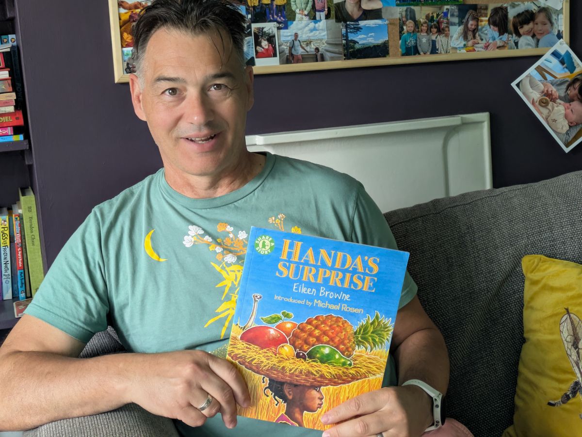 Grandpa holding the
book Handa's Surprise